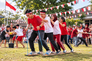 The excitement of the traditional *bakiak* (wooden clog) race celebrating Indonesia's Independence Day on August 17th, adorned with red-and-white flags.