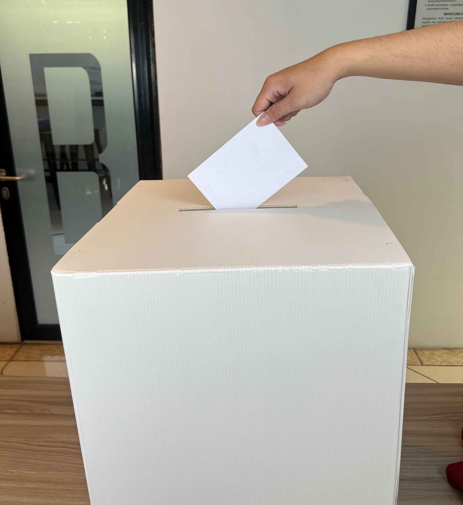 Placing ballots into a PP ballot box made from ALVAboard